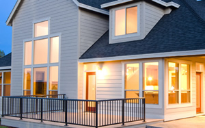 Large house with lights on, evening