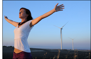 Woman standing near a windfarm